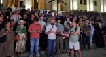 Активисты зачитывают обращение к ЕС. Стоп-кадр видео Publika от 05.07.26,https://www.facebook.com/reel/970950939308170.